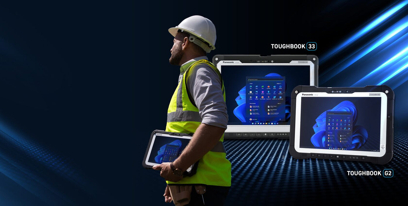 Person in safety gear holding a tablet with TOUGHBOOK branding on a dark background